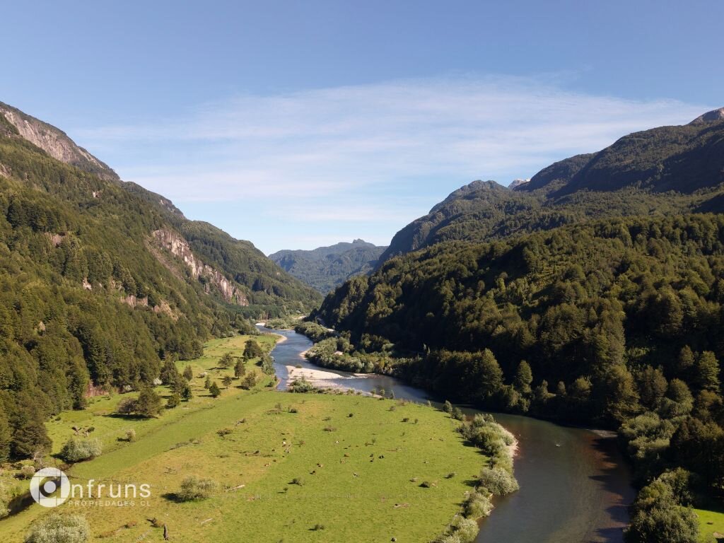 Aerial view of the Coyhaique ranch property showing the Simpson River and grassy fields.